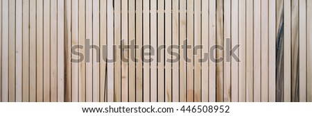 Wooden slats on floor or wall in vertical parallel pattern, background panel texture, horizontal image