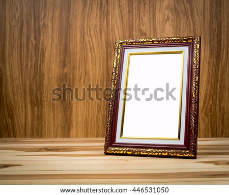 Vintage photo frame on wooden table With a background of wood