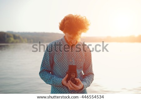 The red-haired guy holding a medium format film camera in his hands