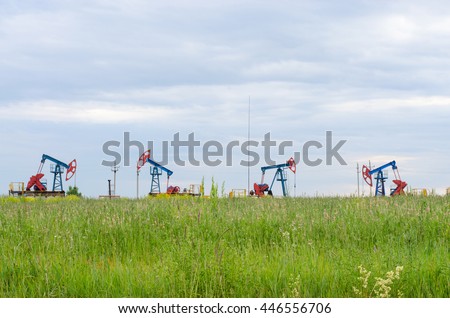 Oil production on the background of grass and sky