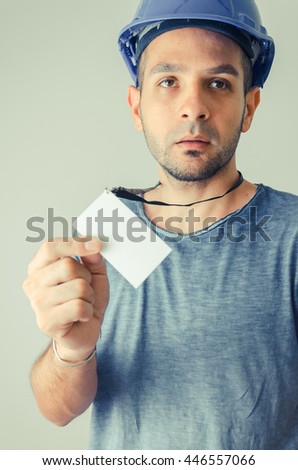 Worker with protective cap showing id card