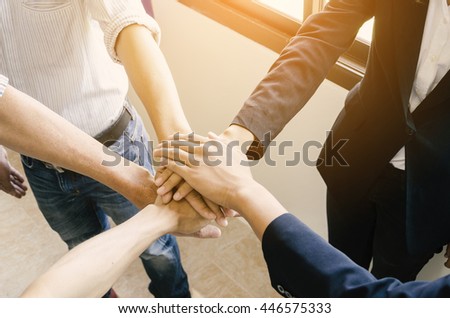 The concept of success: Close-Up of hands business team showing unity with putting their hands together.