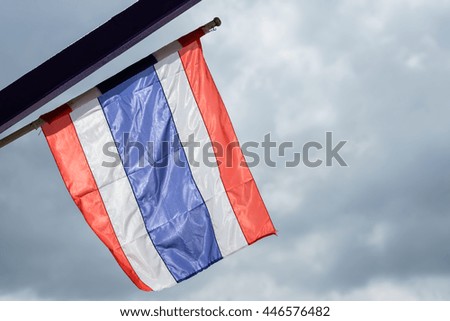 Thailand national flag waving windy with cloudy sky and sunlight, space for background use of texture