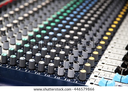 Part of a professional sound mixing console, music device for audio signals with controlling knobs and faders