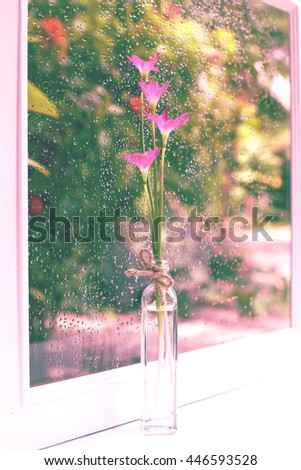Rain lily flower in lovely bottle on vintage background.
