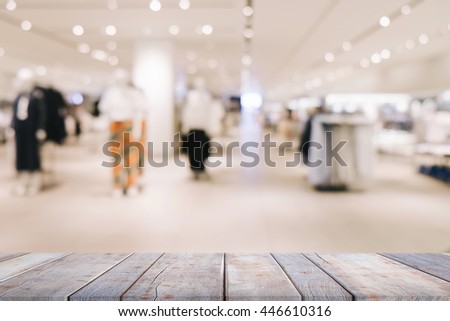 Wooden board empty table in front of blurred background. Perspective light wood over blur in shopping mall - can be used for display or montage your products.

