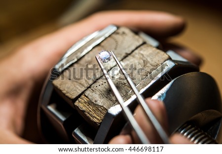 Craft jewelery making with professional tools. Ring repairing. Putting the diamond on the ring. Macro shot.  A handmade jeweler process, manufacture of jewelery. Royalty-Free Stock Photo #446698117