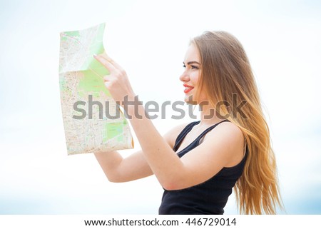 Young woman traveling in country by weekend. searching road on the map. looking place for photo