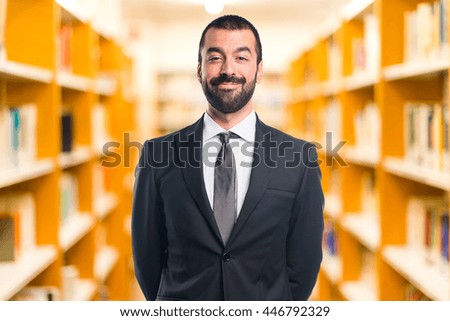Businessman on unfocused library