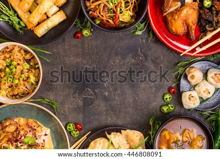 Chinese food dark background. Chinese noodles, fried rice, dumplings, peking duck, dim sum, spring rolls. Famous Chinese cuisine dishes set. Space for text. Top view. Chinese restaurant concept Royalty-Free Stock Photo #446808091
