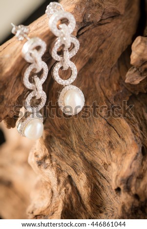 beautiful earring with wooden background 