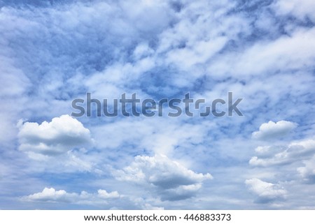 white fluffy clouds in  blue sky                                     