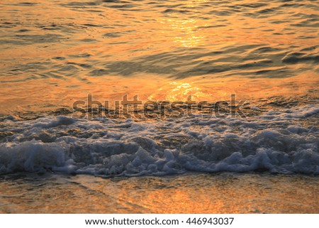 Soft wave on the beach with gold lighting in the morning:Close up,select focus with shallow depth of field:ideal use for background.