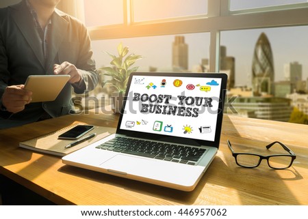BOOST YOUR BUSINESS Thoughtful male person looking to the digital tablet screen, laptop screen,Silhouette and filter sun