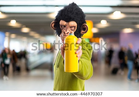 Monkey man with spray on unfocused background