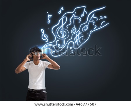 Stylish african american guy in shades and cap listening to music on dark background with abstract sketch