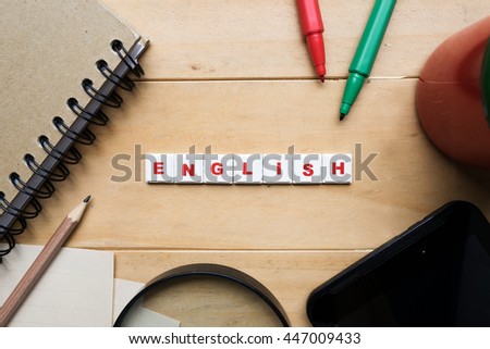 the word "English" spelled using letter tiles on wooden background
