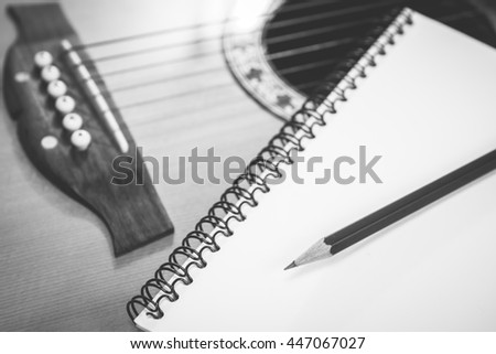 Black and White, Notebook  and pencil with guitar - Vintage retro picture style, Concept of music