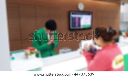 Blur image background, male bank employees sawatdee a senior customer blur image