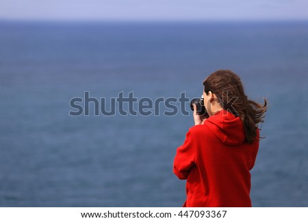 Photographer girl on sea background