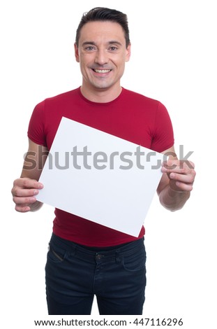 smiling handsome fitness instructor shows blank banner. isolated on white background