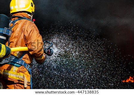 Firefighters spray high-pressure water to extinguish fire with copy space for text