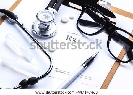 Empty prescription  lying on table with stethoscope