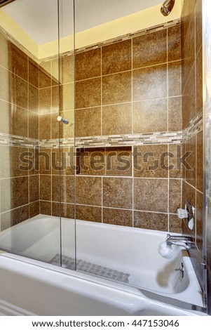 Brown stone tile shower with close up in the bathroom