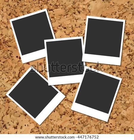Cork board with five scattered blank instant photo cards