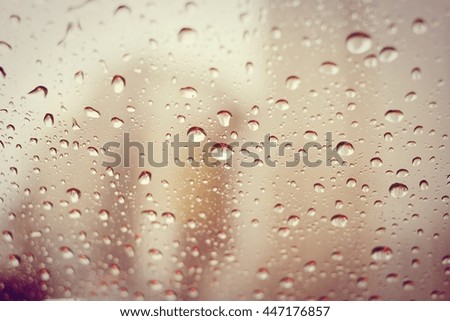 A very rare rainy day with car and people as seen through car windows with rain drops visible on the window. In The Evening.- soft focus