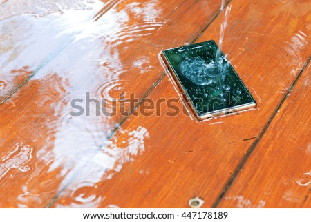 Telephone can waterproof on wood background in daylight,drop water 