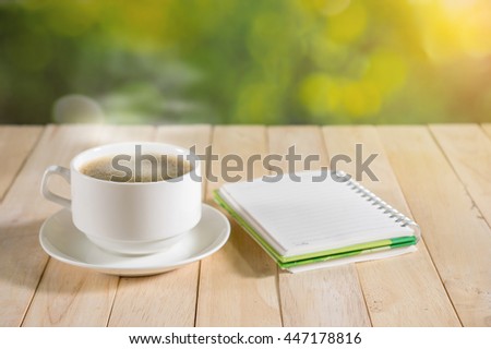 warm cup of coffee on nature background.