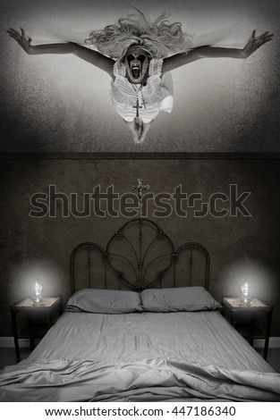 Possessed Woman hovering over a bed Royalty-Free Stock Photo #447186340