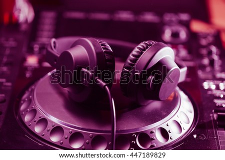 Dj headphones on cd turntable. Professional disc jockey turntables on concert stage. Disk jokey turn table and headset. Play music set on party in night club
