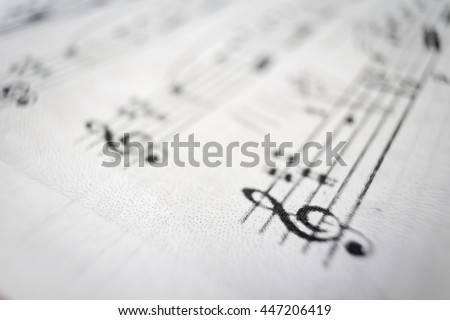 A music score sheet with the focus on the G-clef.
