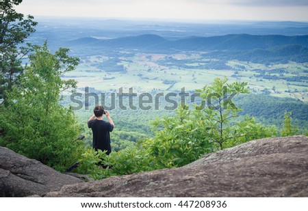 Tourist taking pictures at mountain top