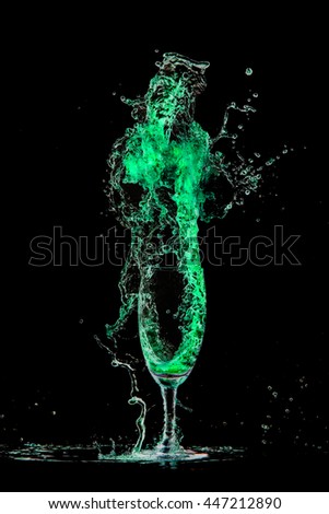 
Drink Cocktail green. Splash out of glass on a black background.
