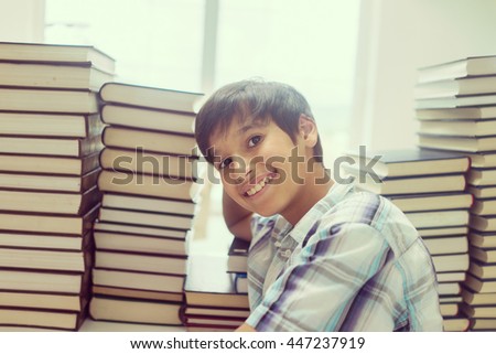Kid with a lot of books