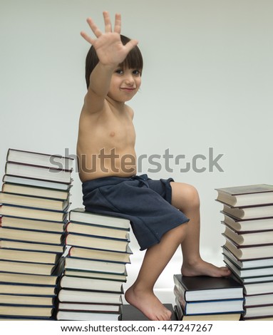Kid walking steps up a lot of books