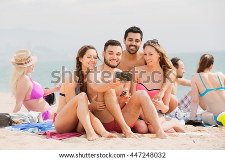 Positive friends doing selfie picture  at sea shore on vacation