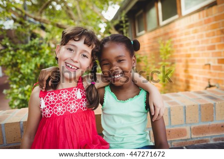 Two friendly girl posing and smiling at the camera Royalty-Free Stock Photo #447271672