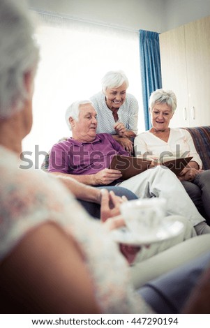 Seniors looking at pictures in the retirement house