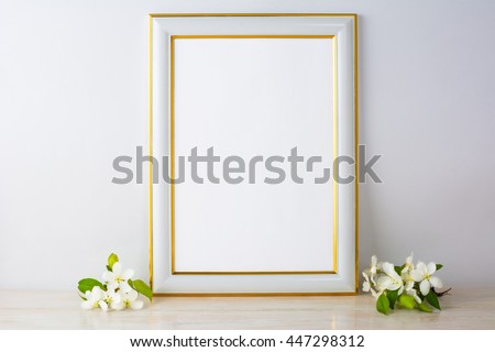 White frame mockup with apple blossom. Empty white frame mockup for design presentation. Portrait or poster white frame mockup romantic style.