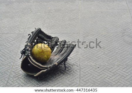 old softball in old glove softball.