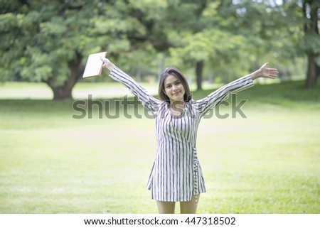 Attractive woman reading a book in the park 
