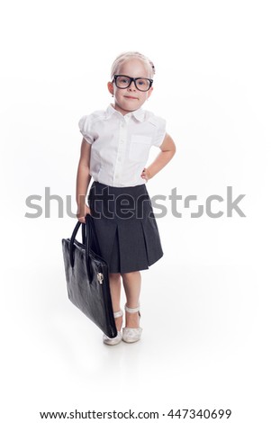 Little girls in glasses standing with black handbag on white background. Concept: young business lady