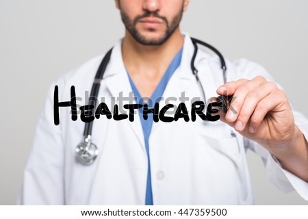 Doctor writing the word Healthcare