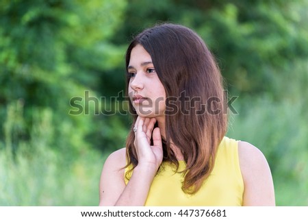 Portrait of a girl with dark hair on the nature