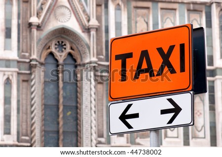 Taxi rank sign with Italian church in background