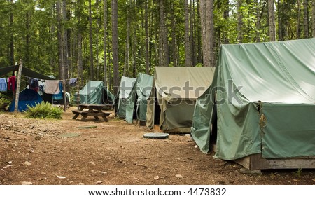 Boy scout campground. A typical campsite at a Boy Scout Camp includes tents, a table, dirt, and dirty clothes drying on a rope. Royalty-Free Stock Photo #4473832